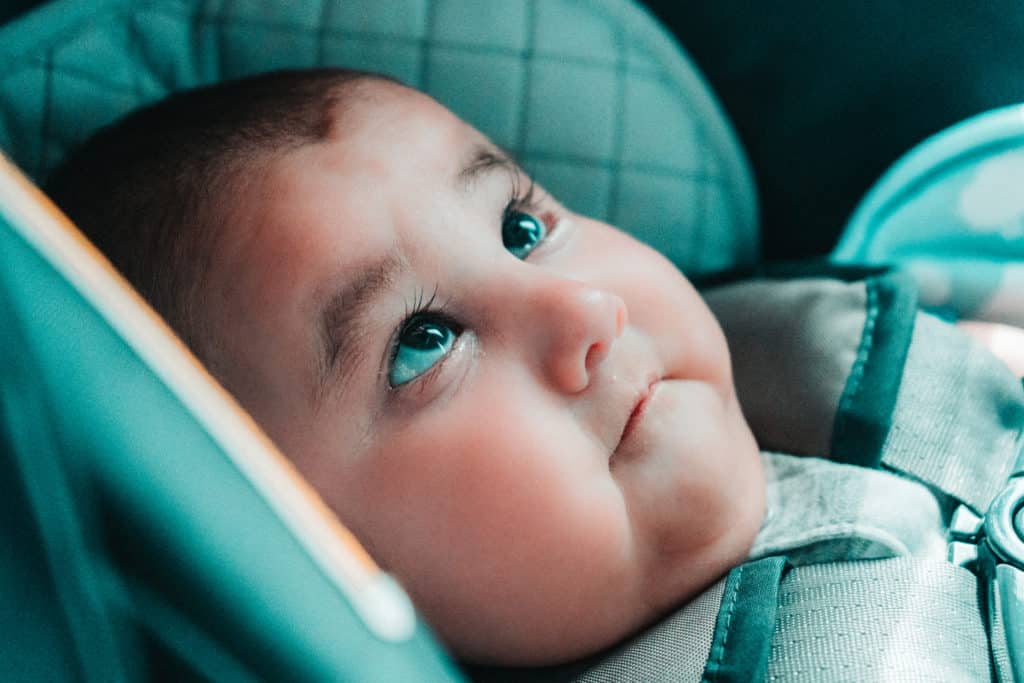 Baby in a car seat looking up