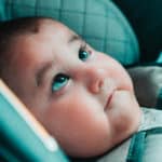 Baby in a car seat looking up