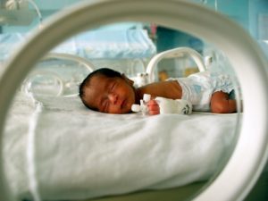 Baby in a NICU incubator